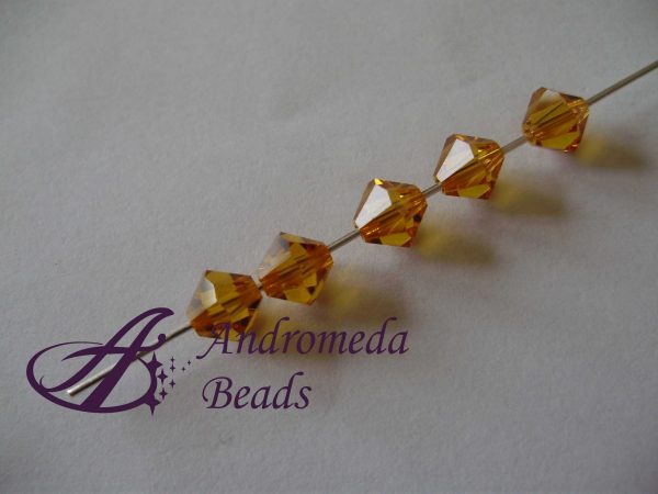 5 Cristalli Swarovski bicono 5301 6mm Topaz - immagine 2